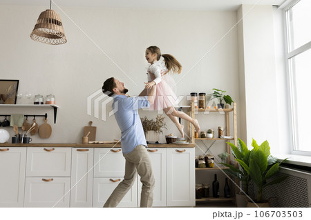 Happy strong dad playing active games with cheerful excited girl Happy strong dad playing active games with cheerful excited girl 106703503