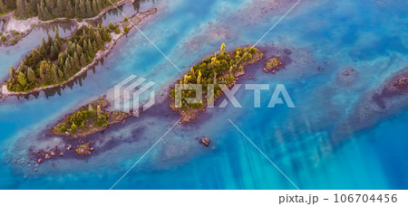 Aerial View of Rocky Islands and Green Trees on Glacier Lake. Garibaldi, Whistler, British Columbia, Canada. Nature Background Aerial View of Rocky Islands and Green Trees on Glacier Lake. Garibaldi, Whistler, British Columbia, Canada. Nature Background 106704456