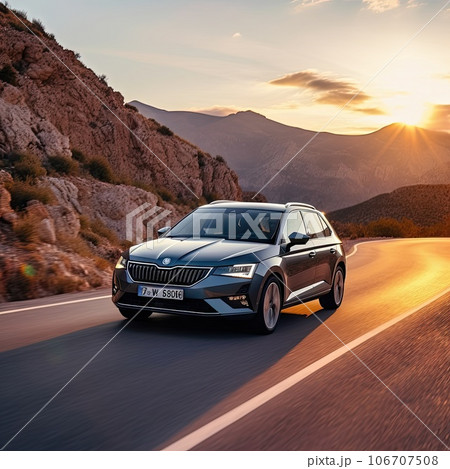 a car driving down a road with the sun setting. Moving car a car driving down a road with the sun setting. Moving car 106707508