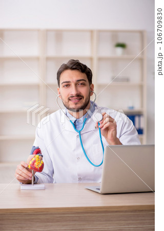 Young male doctor cardiologist working in the clinic Young male doctor cardiologist working in the clinic 106709830