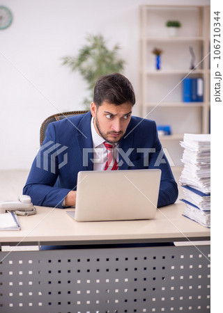 Young male employee working in the office 106710344
