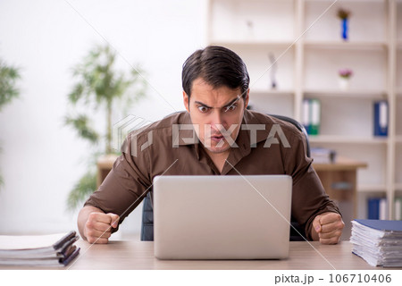Young attractive employee sitting in the office Young attractive employee sitting in the office 106710406