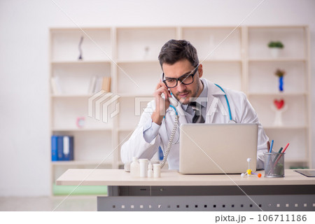 Young male doctor in telemedicine concept 106711186