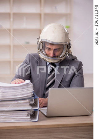 Young male employee wearing spacesuit in the office 106711348