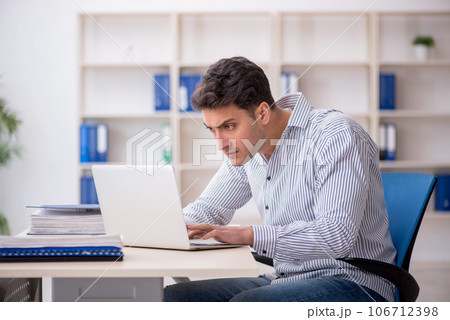 Young male employee working in the office Young male employee working in the office 106712398