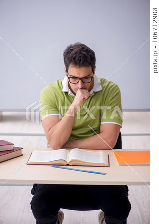 Young male student sitting in the classroom 106712908