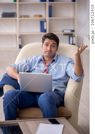 Young male employee sitting in the office 106712910