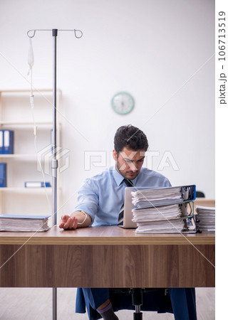Young male employee suffering at workplace Young male employee suffering at workplace 106713519