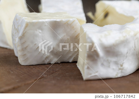 delicious white cheese sliced on a board 106717842