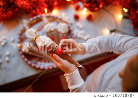 Little preschool girl holding reindeer made with chocolate cocoa powder and marshmallows. Selfmade dessert drink for children on Christmas. Little preschool girl holding reindeer made with chocolate cocoa powder and marshmallows. Selfmade dessert drink for children on Christmas. 106718787