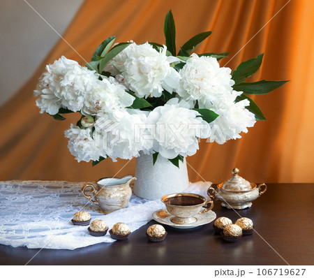 Still life. Coffee, sweets and a bouquet of peonies Still life. Coffee, sweets and a bouquet of peonies 106719627