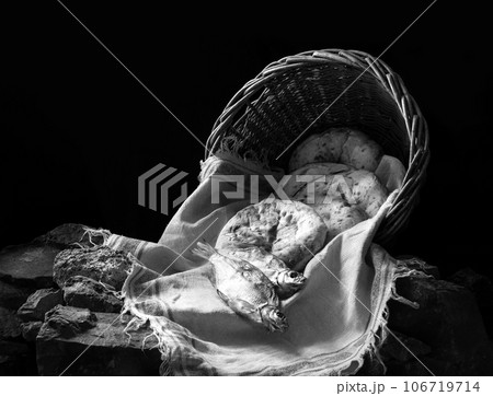 Five loaves and two fish in a basket 106719714