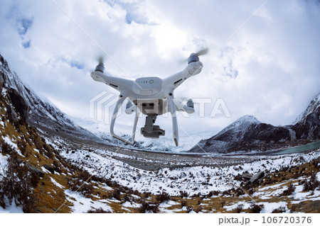 Flying drone taking picture of landscape in Tibet, China Flying drone taking picture of landscape in Tibet, China 106720376