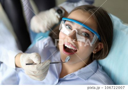 Cute patient opening mouth in doc chair Cute patient opening mouth in doc chair 106722007
