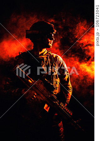 Backlit silhouette of special forces marine on fire explosion background. Battle, bombs exploding, smoke billows Backlit silhouette of special forces marine on fire explosion background. Battle, bombs exploding, smoke billows 106723041