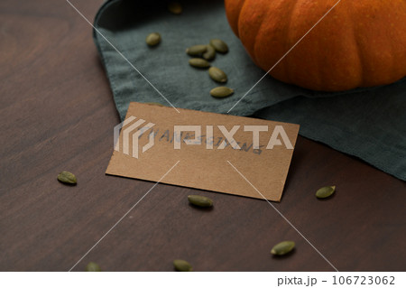 Orange pumpkin with seeds on wood table with thanksgiving paper card 106723062