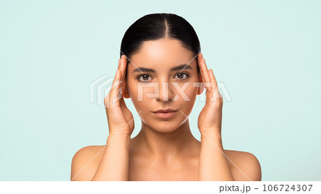 Glamorous natural beauty headshot portrait of a beautiful multiracial Turkish woman with perfect moisturized healthy skin and charming smile naked shoulders Glamorous natural beauty headshot portrait of a beautiful multiracial Turkish woman with perfect moisturized healthy skin and charming smile naked shoulders 106724307