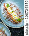 Sweet croissant sandwich dessert filled with whipped cream mixed with custard on blue plate  106724350