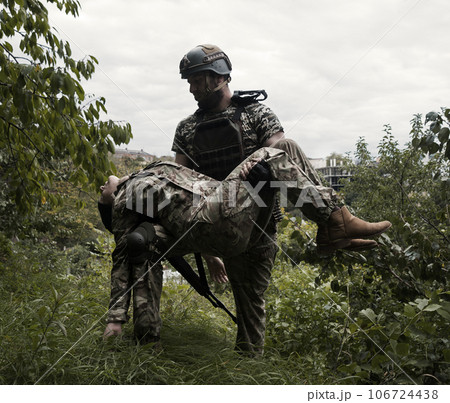 The commander carries a wounded soldier The commander carries a wounded soldier 106724438
