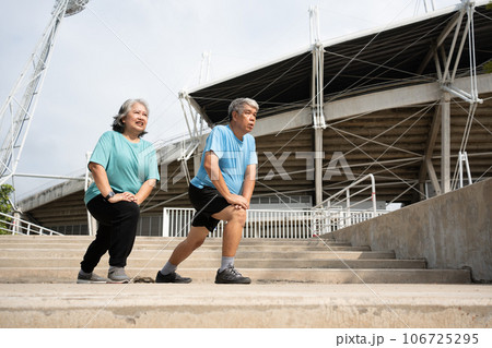 Asian senior couples wear sports outfit and warming up muscles  before exercise at outdoor in the morning. Happy elderly outdoor lifestyle concept, Full length of active happy elderly family couple 106725295