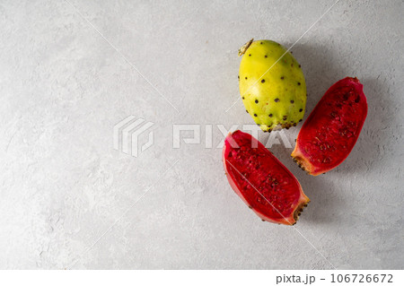 Prickly pears, exotic cactus fruits cut in halves, top view. Copy space Prickly pears, exotic cactus fruits cut in halves, top view. Copy space 106726672