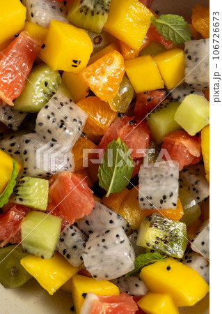 Exotic fruit salad with fresh mango, dragon fruit, grapefruit, kiwi. Exotic fruit salad with fresh mango, dragon fruit, grapefruit, kiwi. 106726673