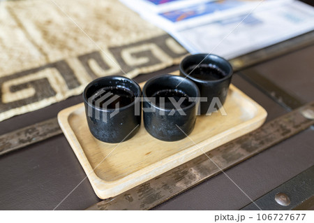 Close-up of three refreshing Thai herbal tea welcome drinks on a rectangular wooden tray. of a hotel in Thailand Impressive feeling in the atmosphere of the hotel on a hot day that makes you smile. 106727677