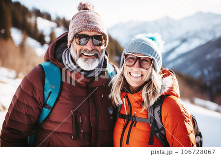 Family happy age couple or friends in winter clothes on the background of snowy mountains Family happy age couple or friends in winter clothes on the background of snowy mountains 106728067