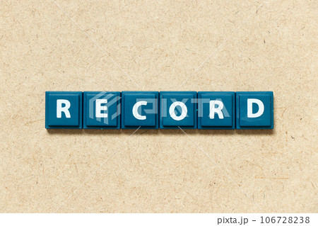 Tile alphabet letter in word record on wood background Tile alphabet letter in word record on wood background 106728238
