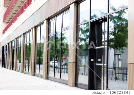 The glass facade of the ground floor building in the city The glass facade of the ground floor building in the city 106728843