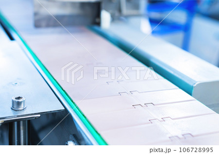 Industrial background. Industrial premises. Industrial metal conveyor. The tape consists of metal plates. Industrial background. Industrial premises. Industrial metal conveyor. The tape consists of metal plates. 106728995