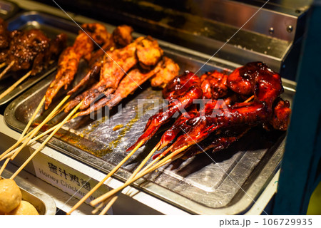 Grilled honey chicken wings in Jalan Alor street food in Kuala Lumpur Grilled honey chicken wings in Jalan Alor street food in Kuala Lumpur 106729935