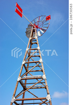 An old windpump against the blue sky. An old windpump against the blue sky. 106730563