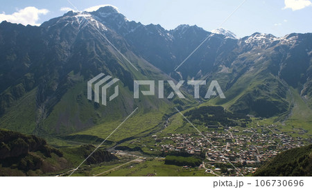 Amazing landscape view of Stepantsminda town in Georgia surrounded by Mountains Amazing landscape view of Stepantsminda town in Georgia surrounded by Mountains 106730696