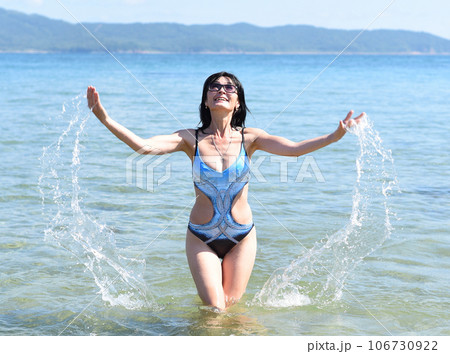 Happy 45 years old Russian woman swimming Japanese sea Happy 45 years old Russian woman swimming Japanese sea 106730922