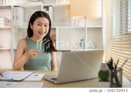 Young woman Working from Home, Video Call with Customer in Office, Remote Business Communication, Telecommuting Professional, Virtual Video Call with Office Customer, Work from Home Concept. 106730953