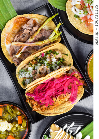 Tacos with sauces on gray background top view closeup 106731185