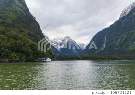 Photograph of tour boat cruising with tourists in Milford Sound on the South Island of New Zealand 106731221