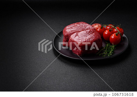 Raw fillet steak mignon beef with salt, spices and herbs Raw fillet steak mignon beef with salt, spices and herbs 106731618