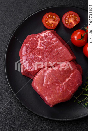 Raw fillet steak mignon beef with salt, spices and herbs Raw fillet steak mignon beef with salt, spices and herbs 106731623