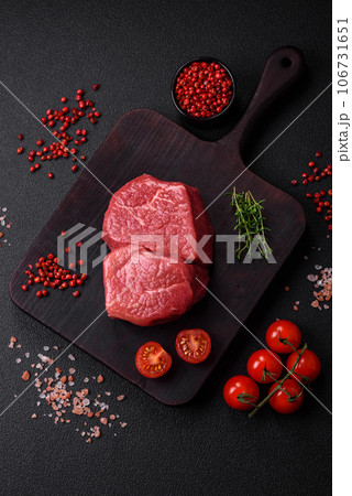 Raw fillet steak mignon beef with salt, spices and herbs Raw fillet steak mignon beef with salt, spices and herbs 106731651