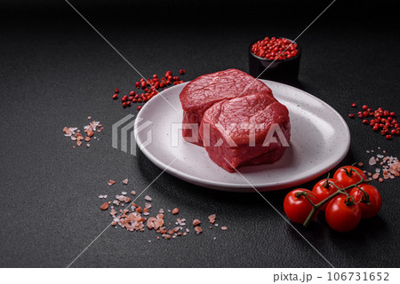 Raw fillet steak mignon beef with salt, spices and herbs Raw fillet steak mignon beef with salt, spices and herbs 106731652