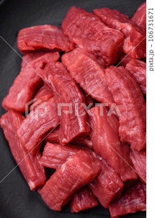 Raw organic meat beef or lamb cut into slices with salt, spices and herbs 106731671