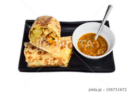Vegetarian Mexican burrito with potato, tofu,rice served with sauce borracha Vegetarian Mexican burrito with potato, tofu,rice served with sauce borracha 106731672