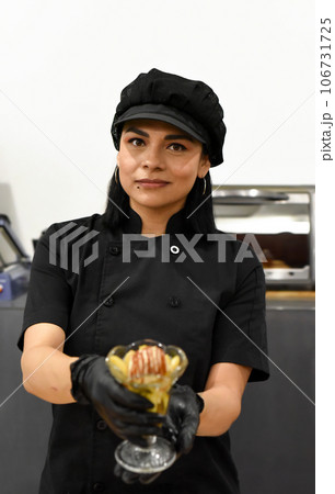 Mexican woman serving santa fe (caramelized banana with whisky) in mexican cafe Mexican woman serving santa fe (caramelized banana with whisky) in mexican cafe 106731725