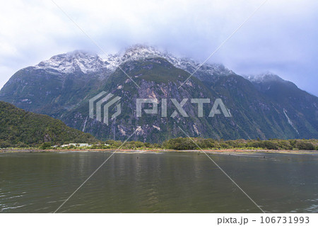Photograph of mountains in clouds and mist in Milford Sound on the South Island of New Zealand Photograph of mountains in clouds and mist in Milford Sound on the South Island of New Zealand 106731993