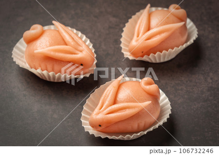 Portuguese marzipan delicacy in the shape of pink hare a rabbit. Gourmet sweets from the Algarve Portugal on a marble background close-up. 106732246