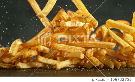 French fries - fried potatoes hitting the table. 106732759