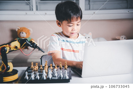 Asian little boy programming code to robot machine arm on laptop for play chess, STEM education E-learning, Funny children learning getting lesson control robot arm, Technology science education Asian little boy programming code to robot machine arm on laptop for play chess, STEM education E-learning, Funny children learning getting lesson control robot arm, Technology science education 106733045