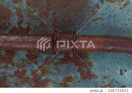 Rusty plumb tube on rusty metal wall Rusty plumb tube on rusty metal wall 106733831
